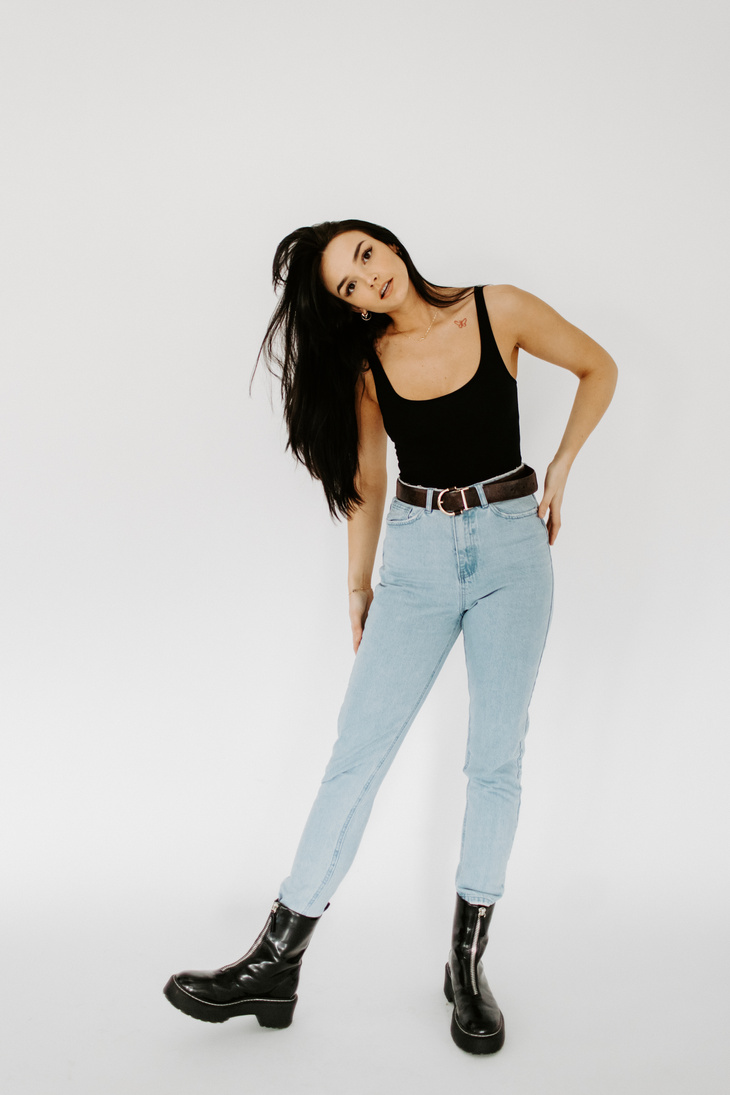 Woman in Black Tank Top and Blue Denim Jeans